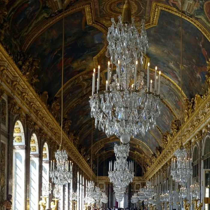 versailles palace hall of mirrors with chandeliers